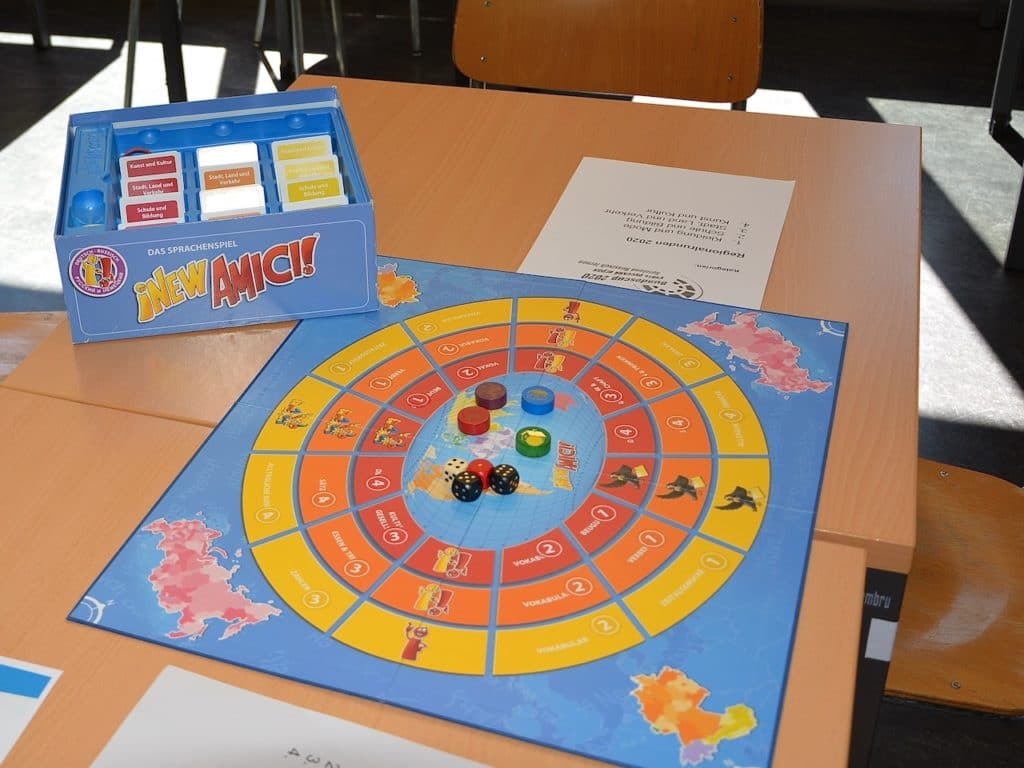 Игру «New Amici!» или «New Amigos!» придумал в начале 2000-х норвежский музыкант Лакки Патей (Lakki Patey) для изучения английского, немецкого и французского. (© forall.swiss)